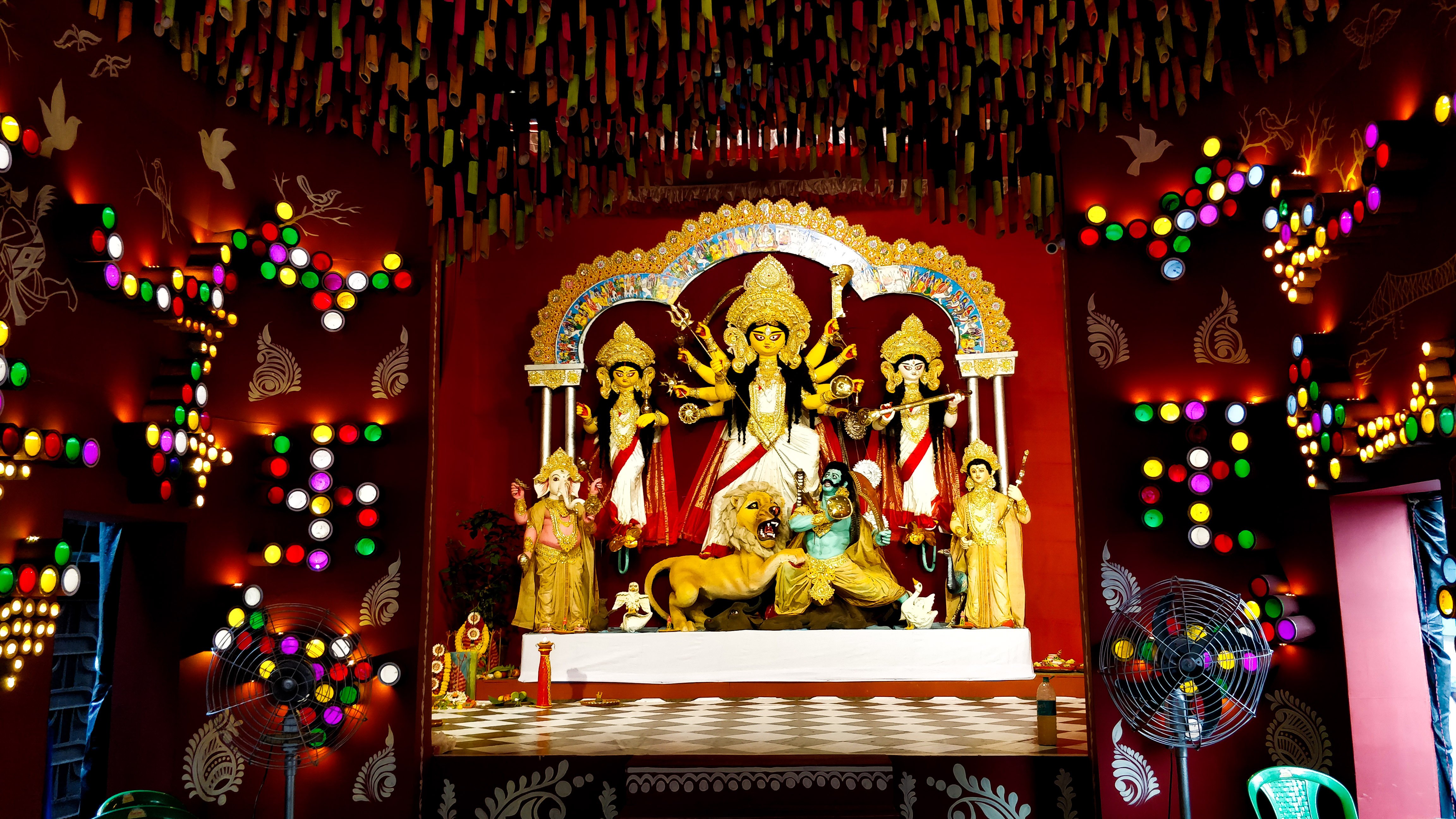 From left - Ganesh, God of success; Lakshmi, Goddess of wealth and prosperity; Durga, Warrior Goddess, Destroyer of Evil; Saraswati, Goddess of wisdom and music; Kartik, God of youth and power
At Durga's feet lies Mahishasura